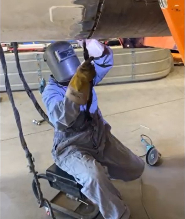 Micron technician welding a tank trailer in the shop